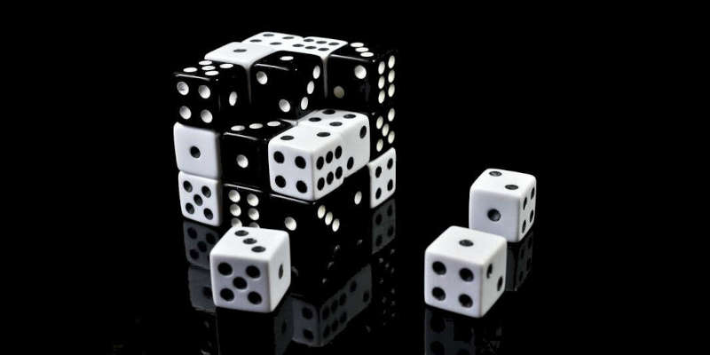 Immagine B/N di un insieme di dadi da gioco organizzati in modo strutturato in un grande cubo di Rubik